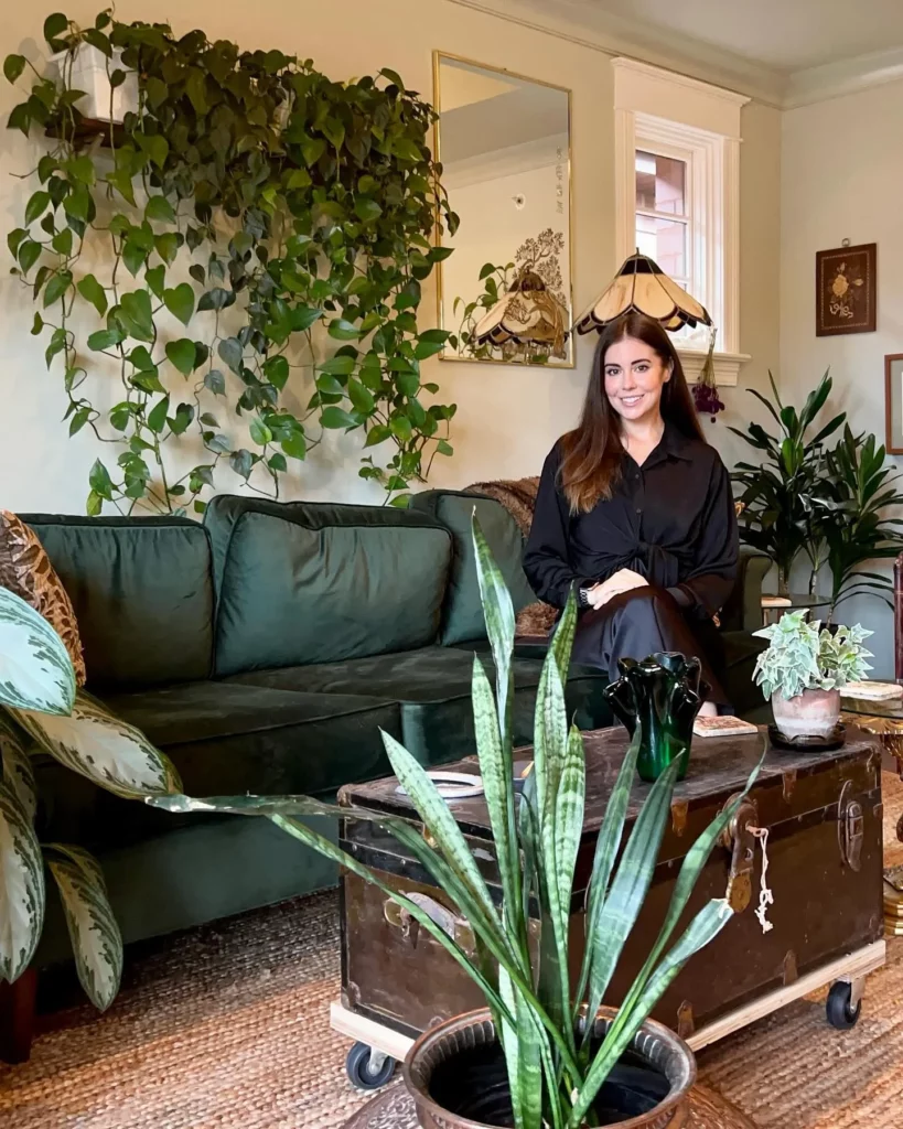 Happy Woman Posing with Snake Plant and Other Indoor Plants at Home Living Area