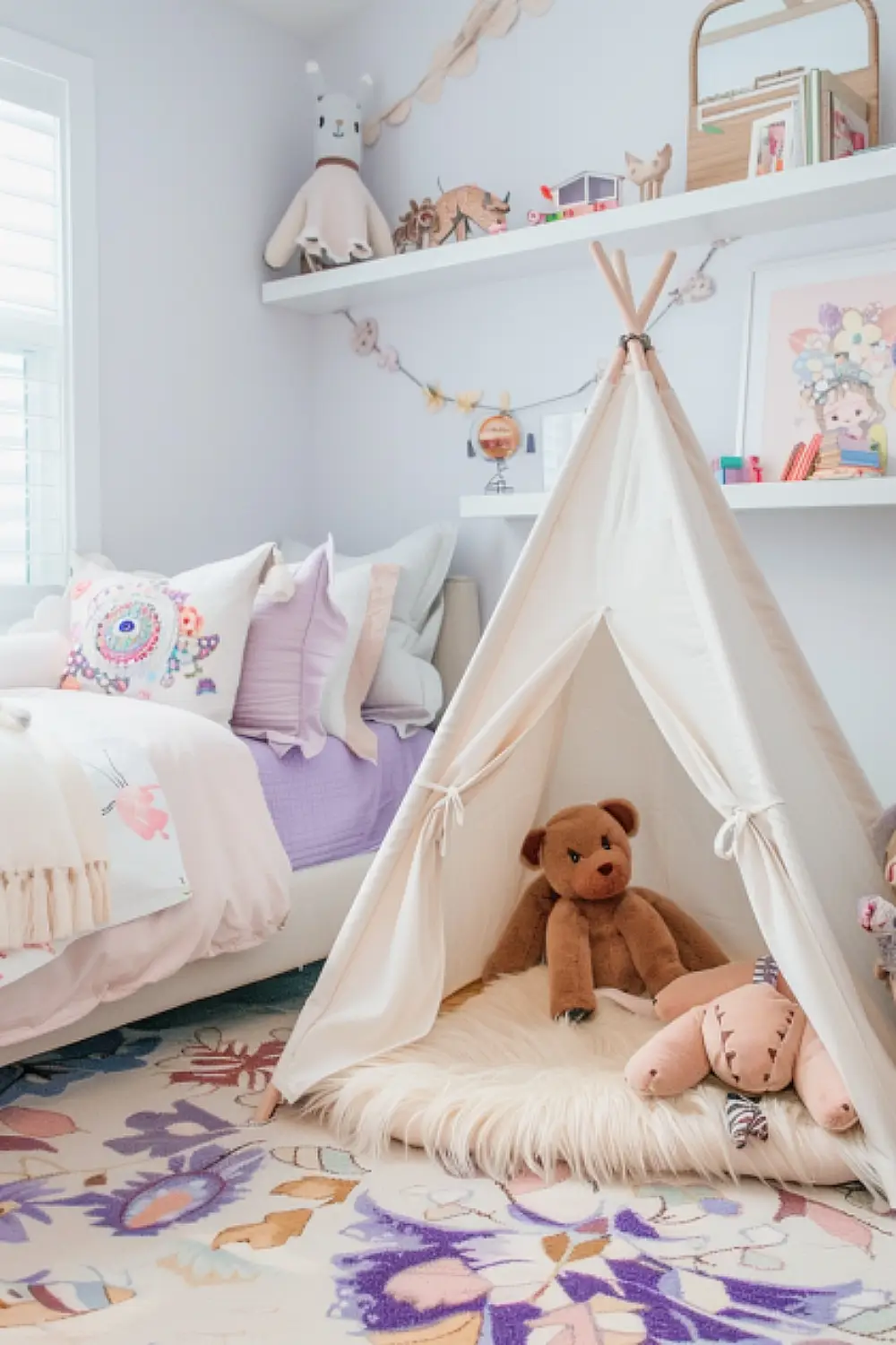 Pastel-colored boho-style bedroom with teepee and plush rugs