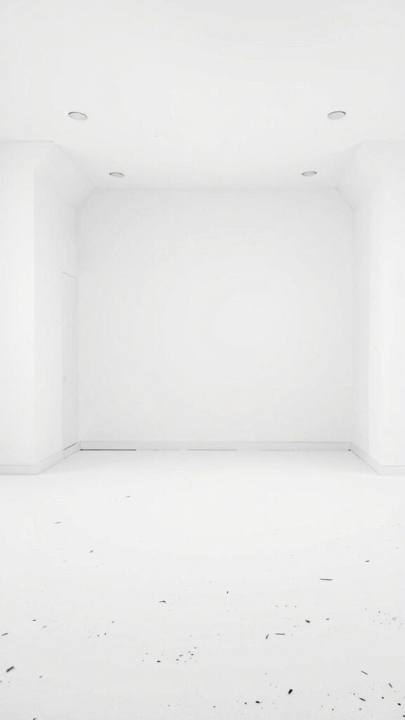 An empty room with bright white walls and floor, lacking texture or color.